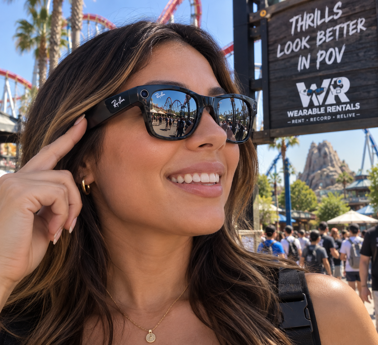 A visitor wearing smart glasses at an amusement park, with a Wearable Rentals sign in the background.